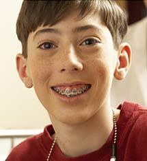 photo of a smiling young boy wearing glasses